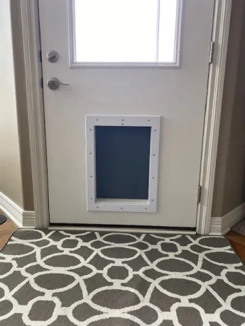 RANGER Pet Door with gray flap, mounted in attractive door